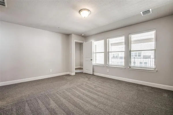 a spacious bathroom with a granite countertop sink mirror and shower