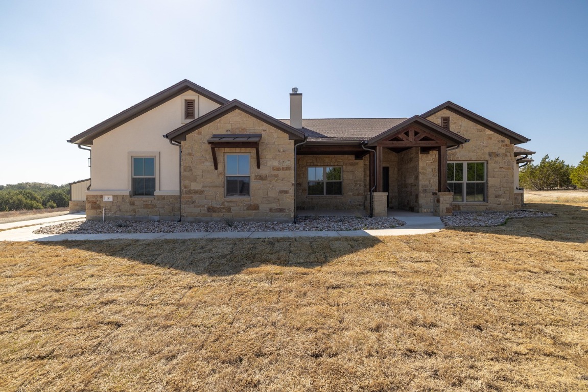 a front view of a house with yard and garage