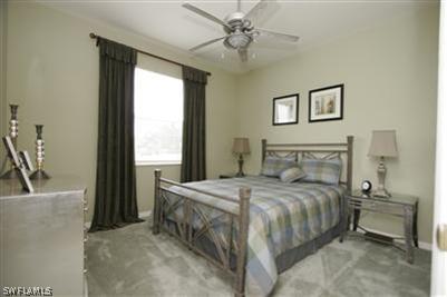 15057 Balmoral Loop Fort Myers, FL 33919 - Photo 6 of 10 a bedroom with a bed and a chandelier
