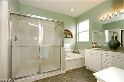 15057 Balmoral Loop Fort Myers, FL 33919 - Photo 10 of 10 a bathroom with a bathtub shower sink vanity mirror and toilet