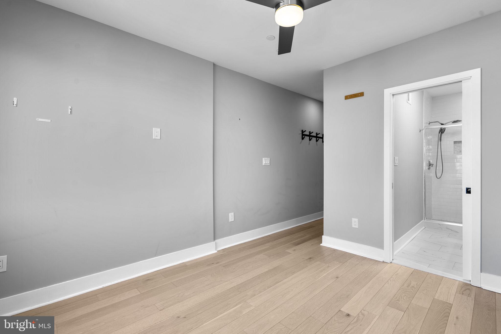 3572 13th Street Northwest, Unit 2 Washington, DC 20010 - Photo 19 of 36 an empty room with wooden floor and mirror