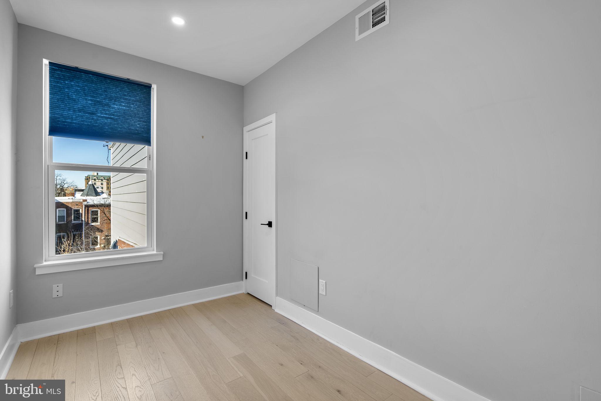 3572 13th Street Northwest, Unit 2 Washington, DC 20010 - Photo 25 of 36 a view of an empty room with wooden floor and a window