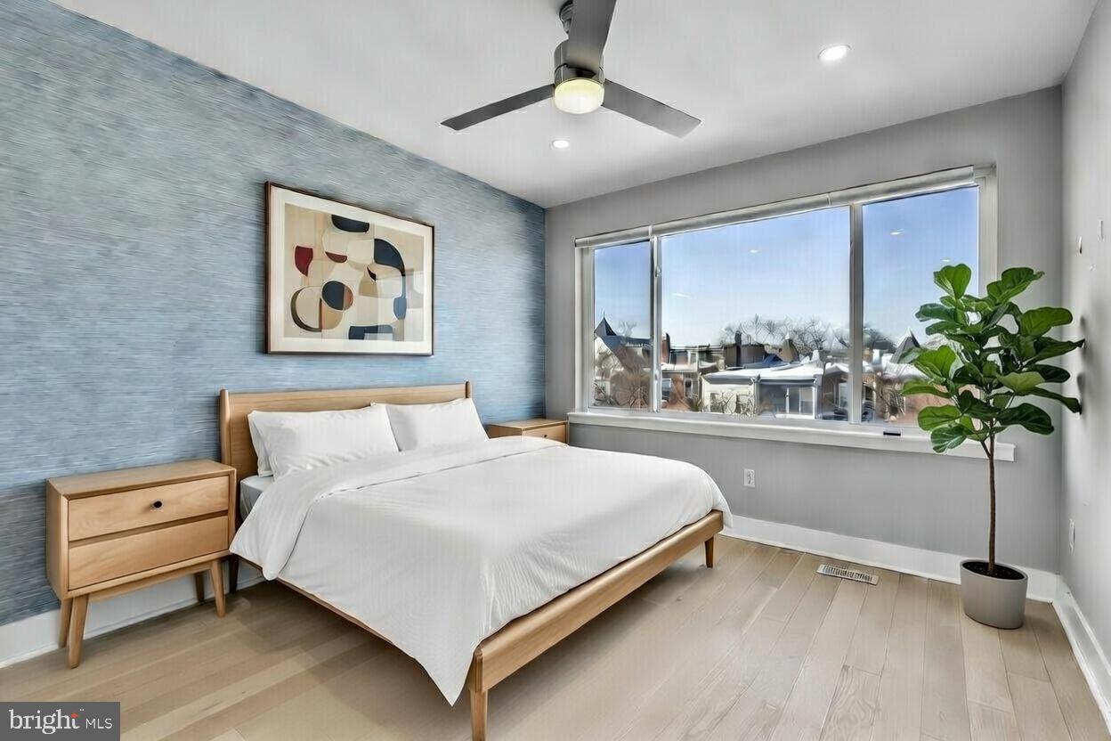 3572 13th Street Northwest, Unit 2 Washington, DC 20010 - Photo 4 of 36 a bedroom with a bed potted plant and a window