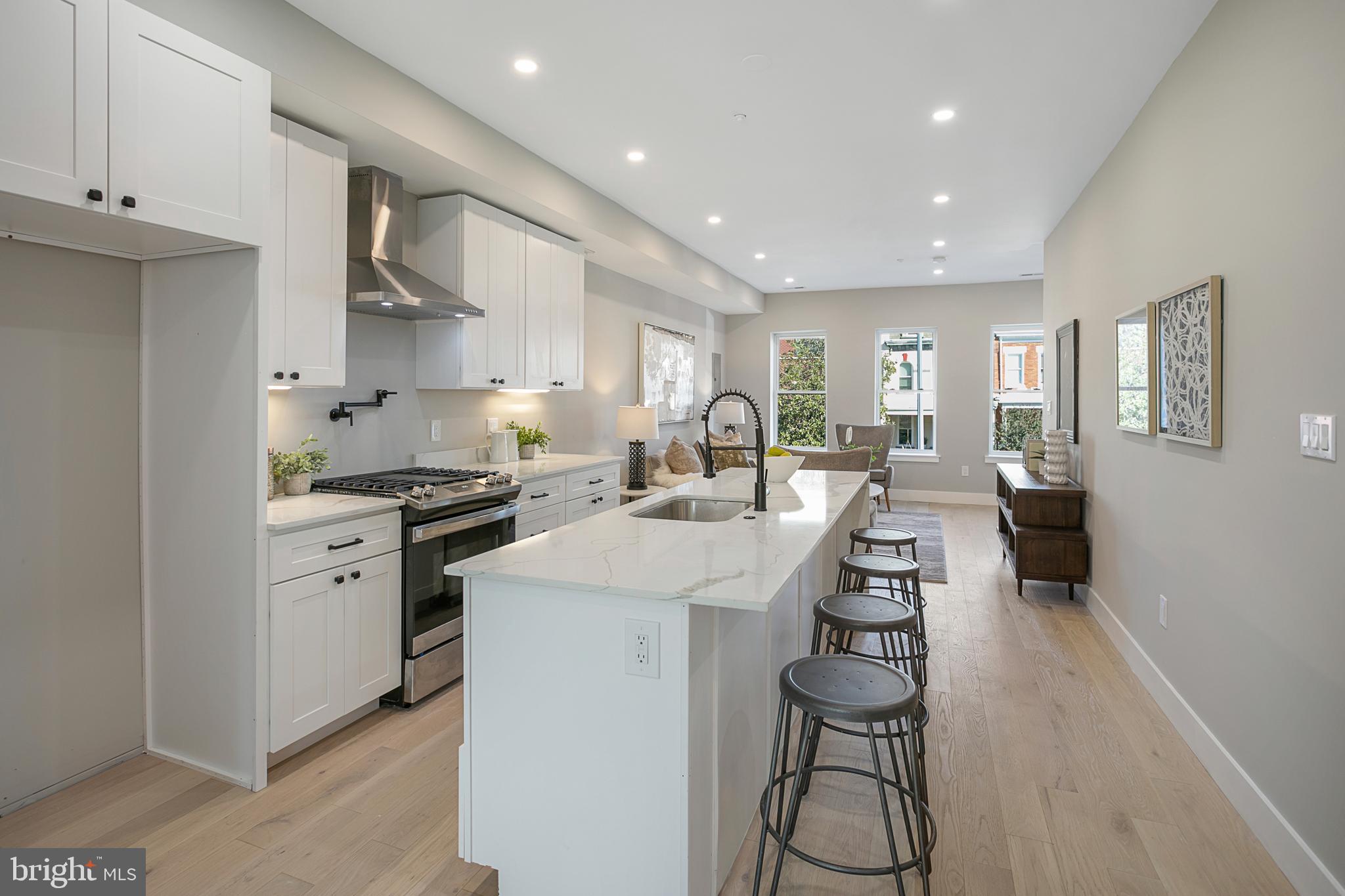 3572 13th Street Northwest, Unit 2 Washington, DC 20010 - Photo 5 of 9 a kitchen with counter top space a sink stainless steel appliances and cabinets