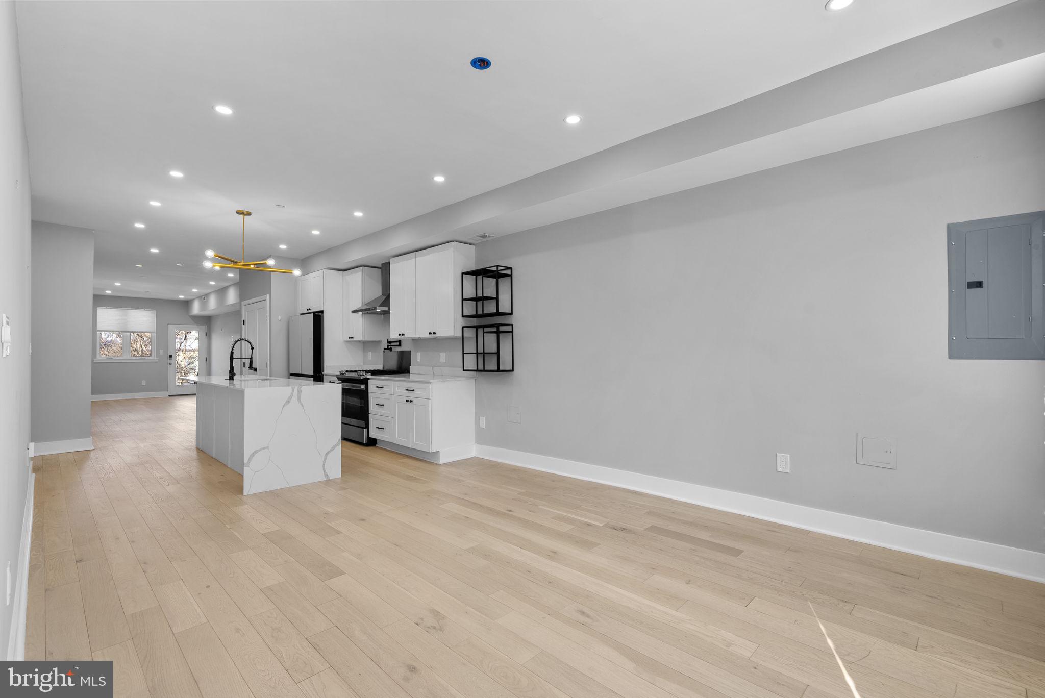 3572 13th Street Northwest, Unit 2 Washington, DC 20010 - Photo 8 of 36 a view of kitchen with kitchen island white cabinets and refrigerator
