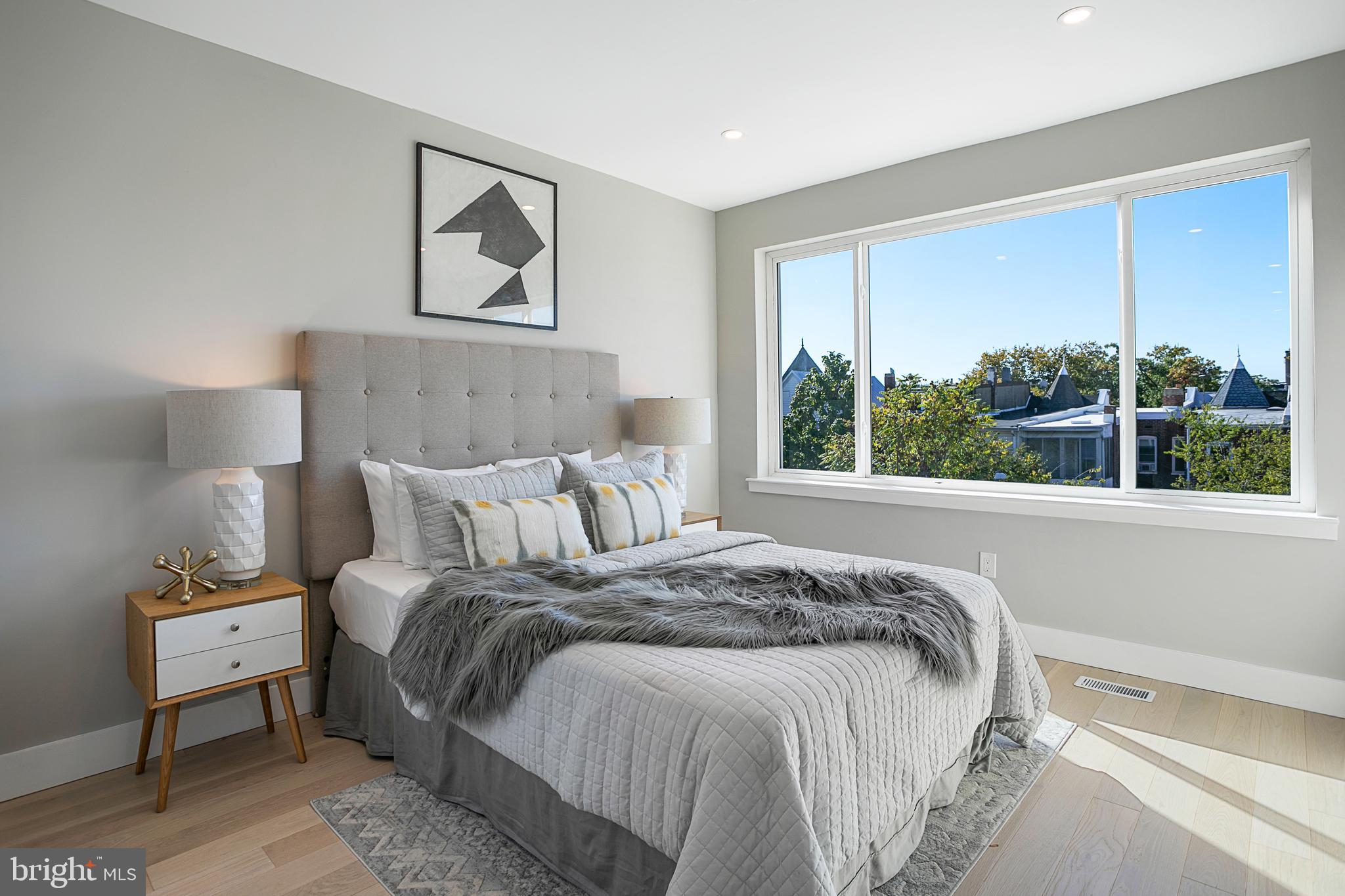 3572 13th Street Northwest, Unit 2 Washington, DC 20010 - Photo 8 of 9 a bed sitting in a bedroom next to a window