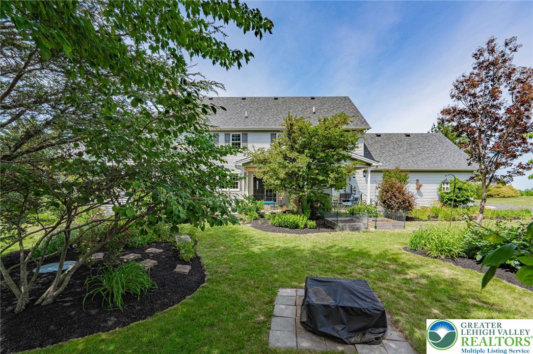 4542 Springfield Drive Coplay, PA 18037 - Photo 71 of 89 A verdant backyard with manicured landscaping and a well-maintained lawn provides a tranquil outdoor retreat.