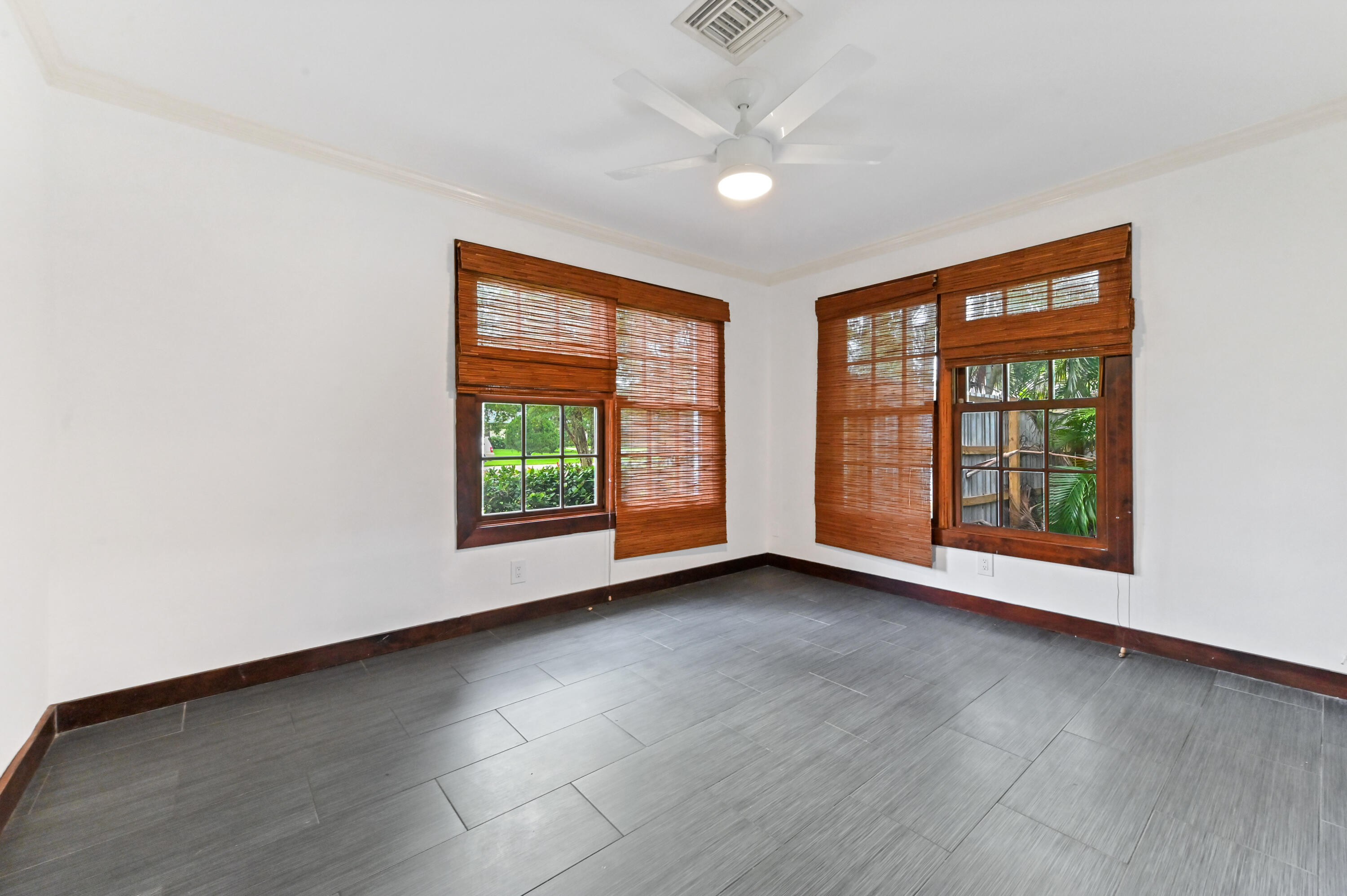 98 Cleveland Road Lake Worth, FL 33467 - Photo 14 of 30 an empty room with wooden floor and windows