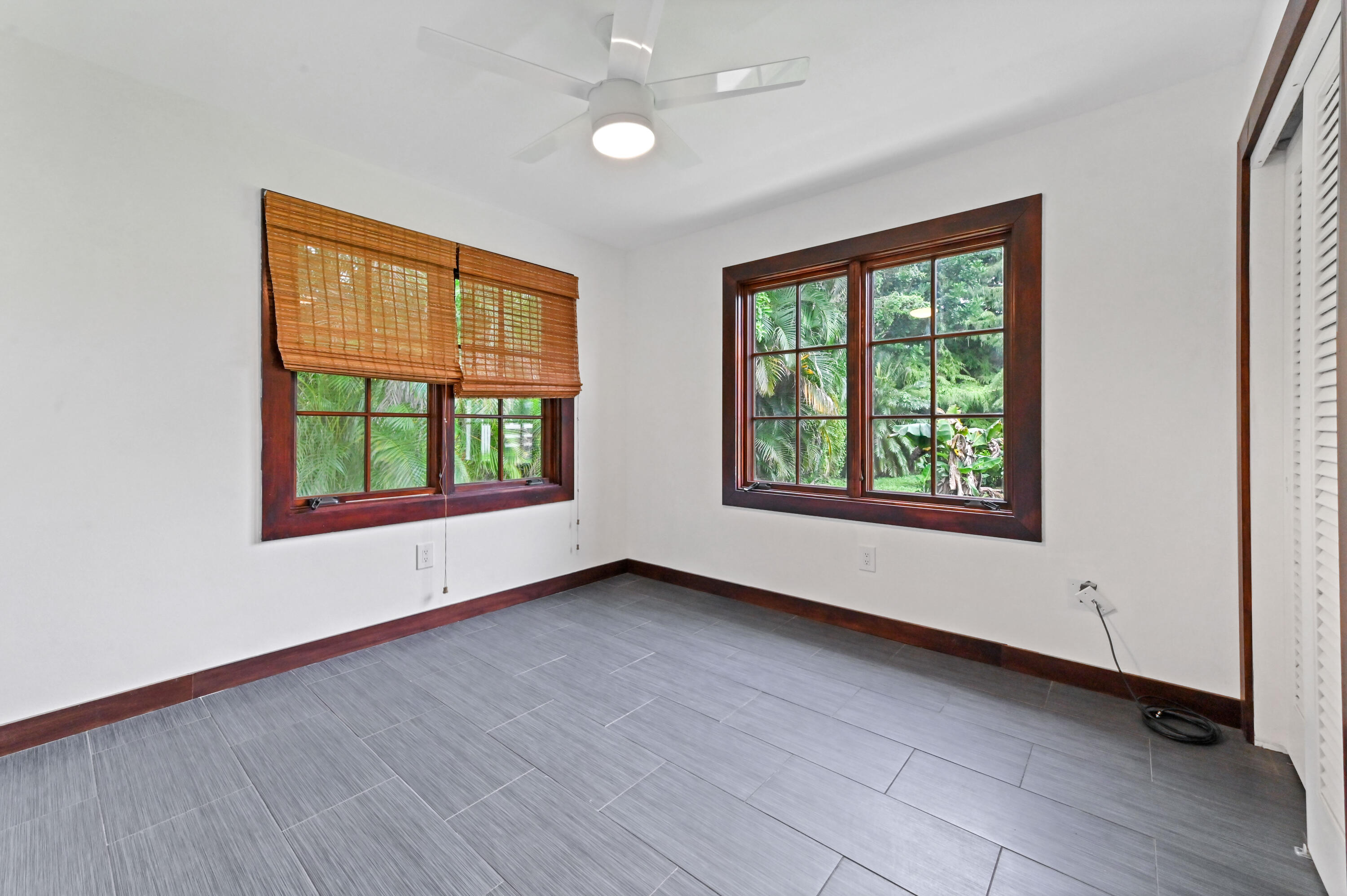 98 Cleveland Road Lake Worth, FL 33467 - Photo 16 of 30 an empty room with wooden floor and windows