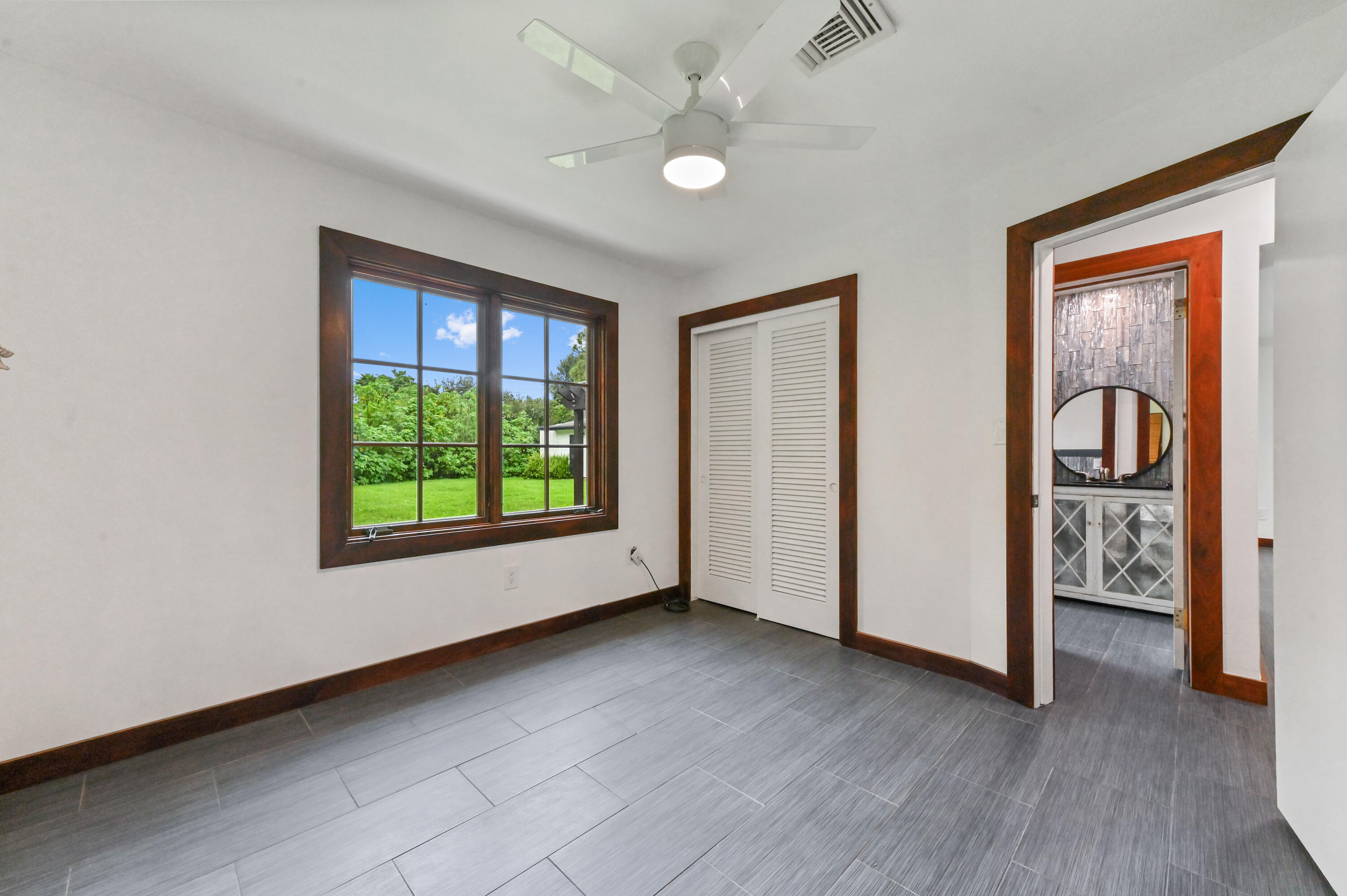 98 Cleveland Road Lake Worth, FL 33467 - Photo 17 of 30 a view of livingroom with window hardwood floor and ceiling fan