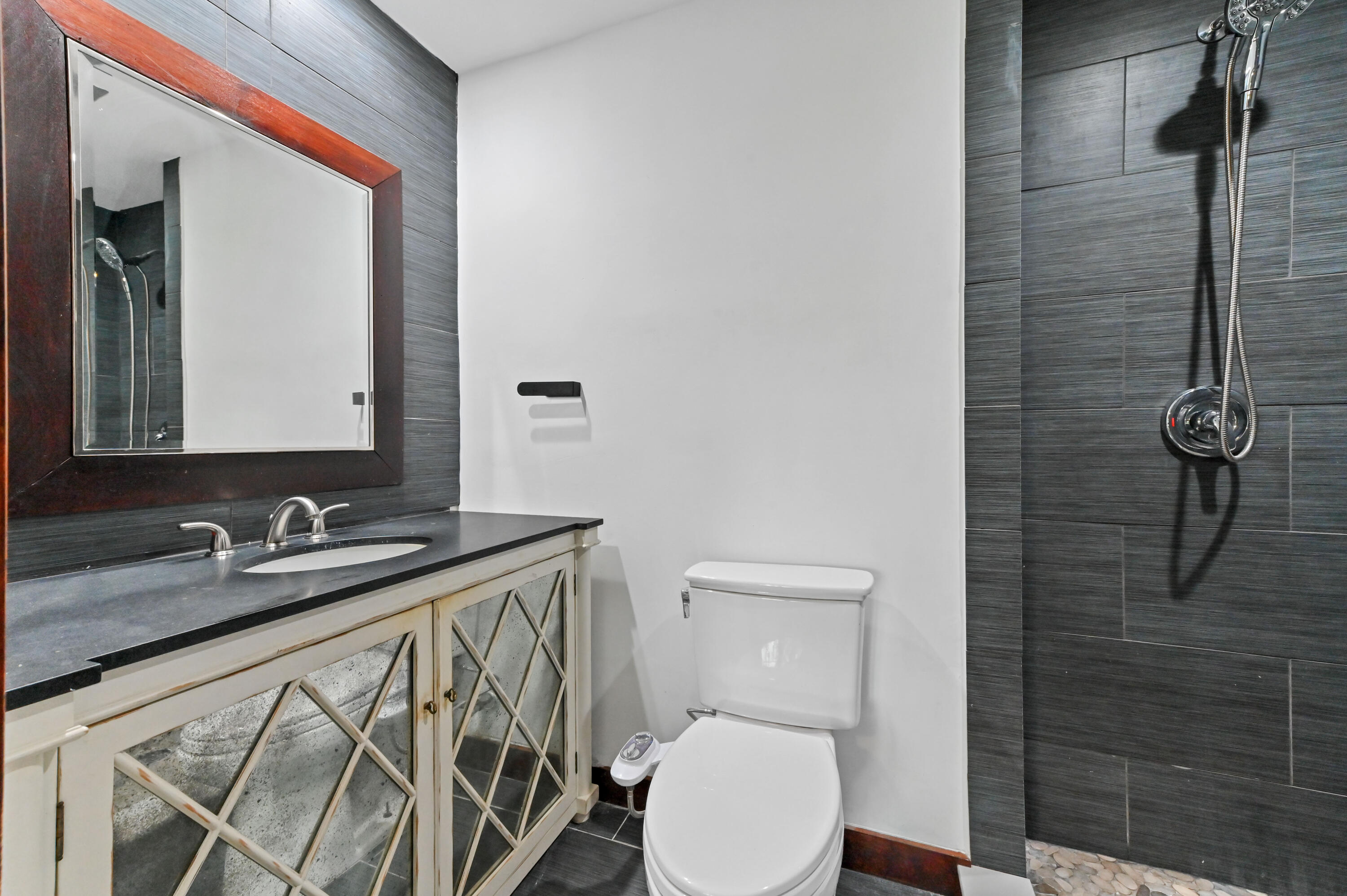 98 Cleveland Road Lake Worth, FL 33467 - Photo 22 of 30 a bathroom with a sink a toilet and shower