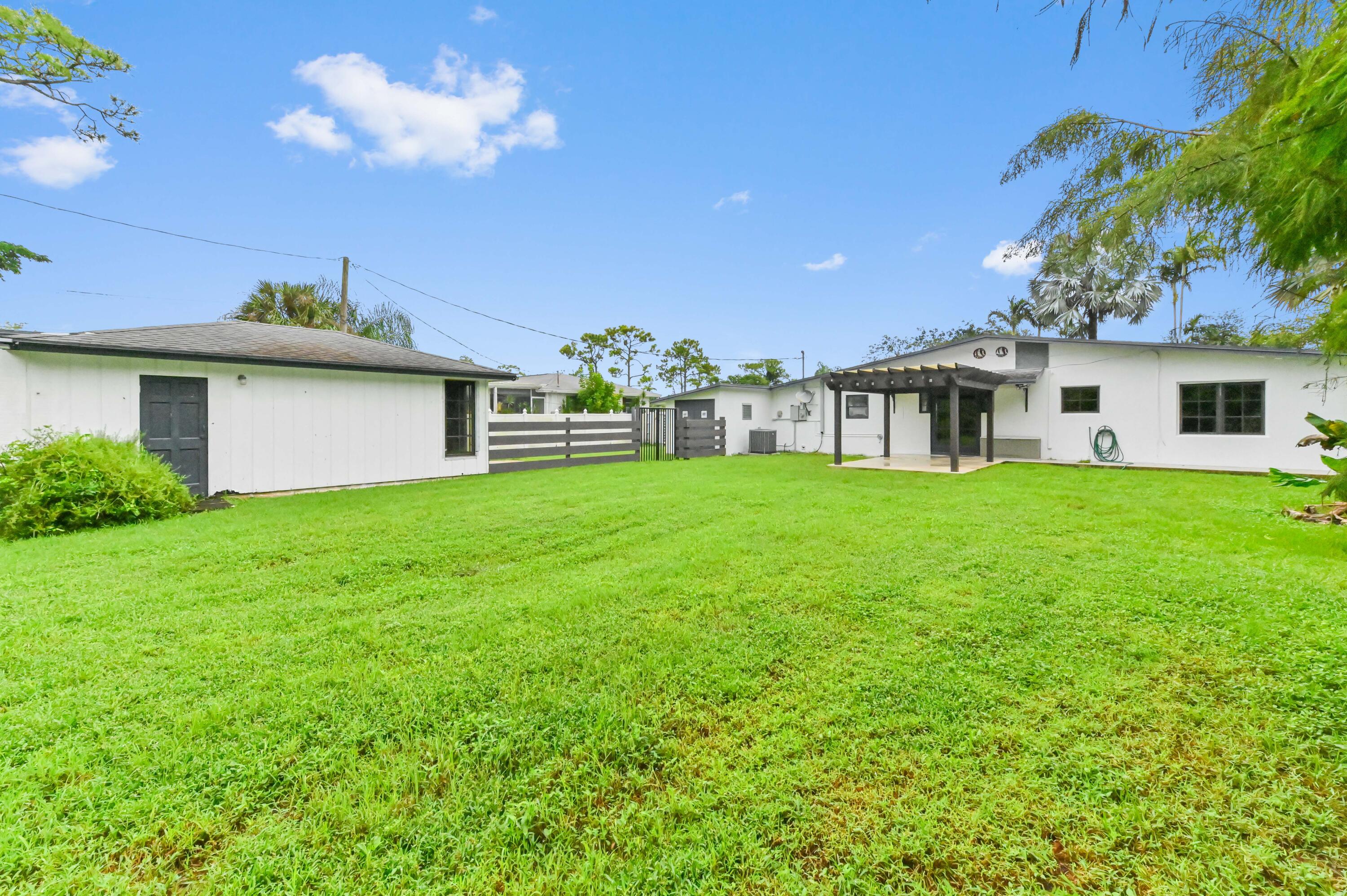 98 Cleveland Road Lake Worth, FL 33467 - Photo 29 of 30 a view of a house with a yard