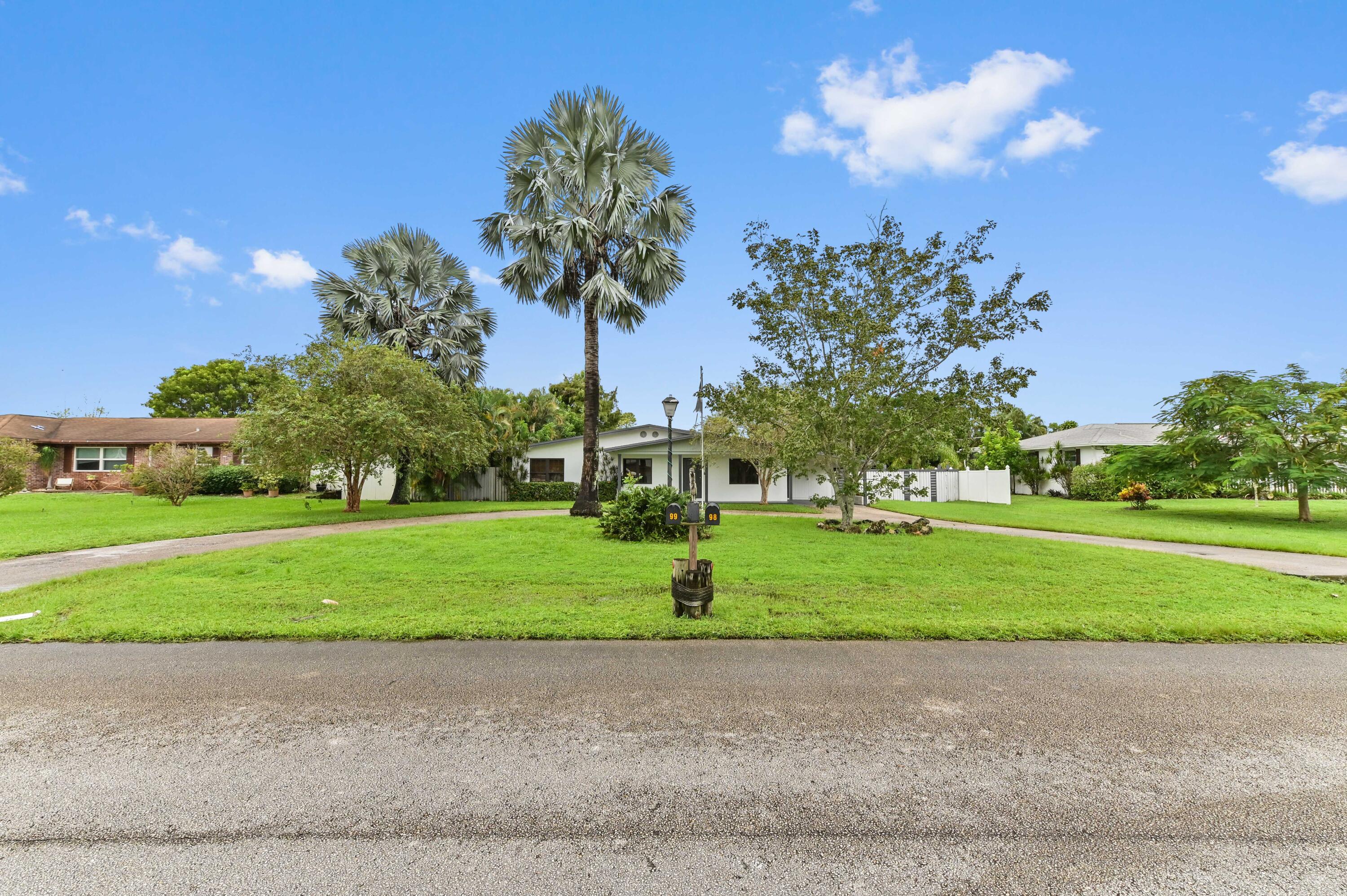 98 Cleveland Road Lake Worth, FL 33467 - Photo 30 of 30 a green field with lots of trees