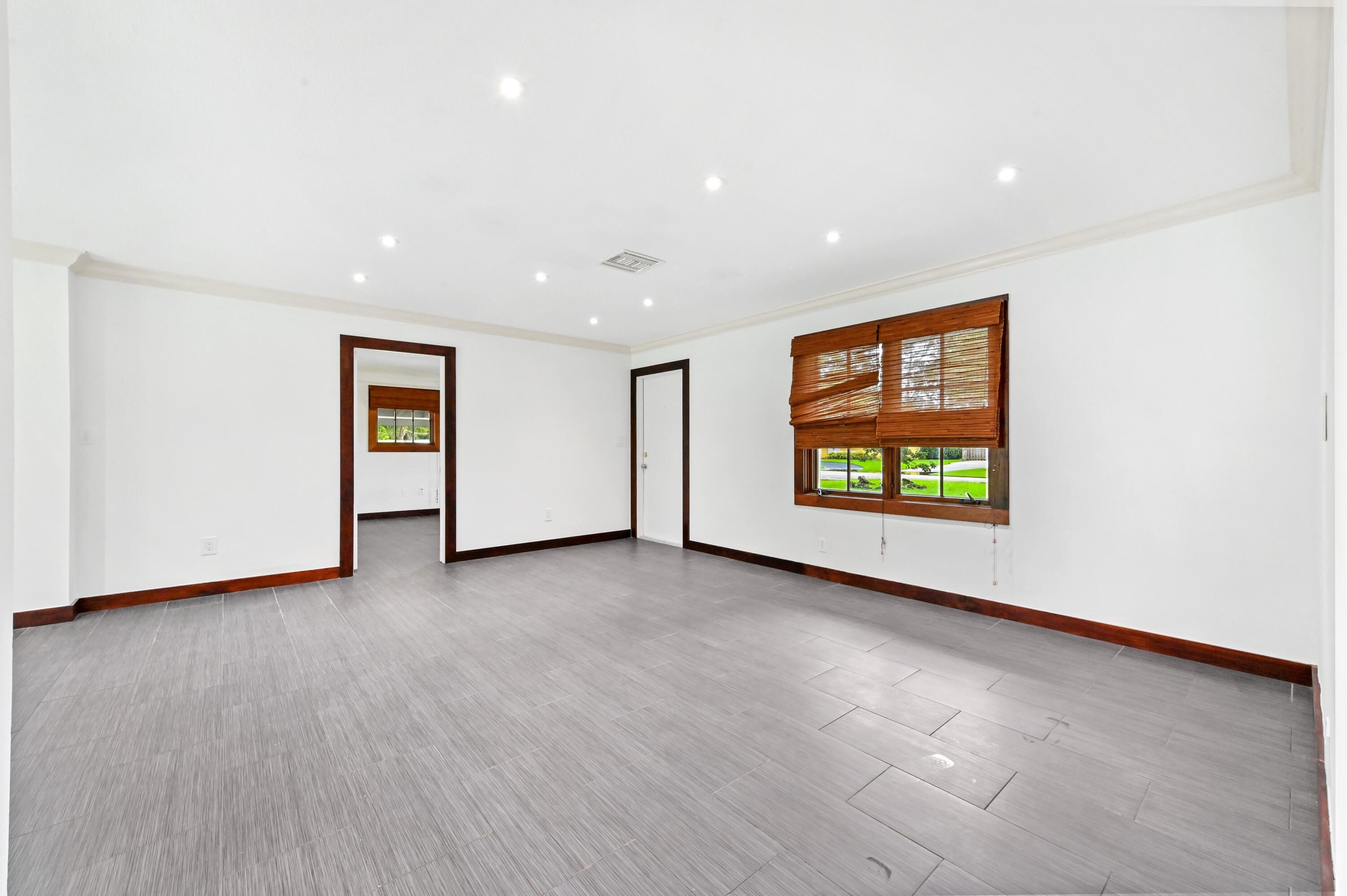 98 Cleveland Road Lake Worth, FL 33467 - Photo 5 of 30 a view of an empty room with a window and kitchen view