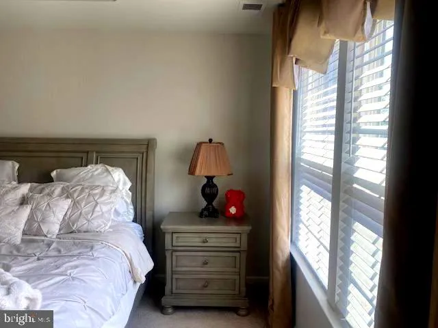 a bedroom with a bed and window