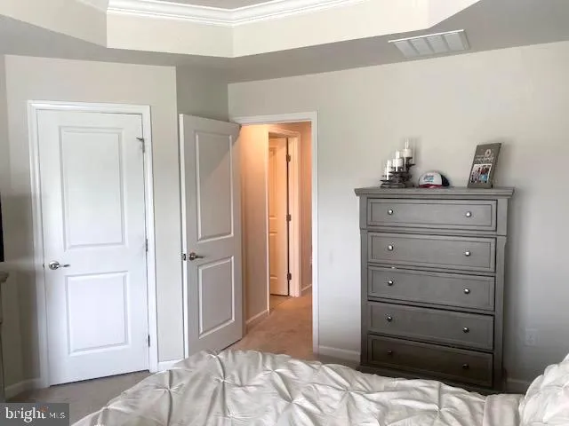 a bedroom with a bed and a dresser