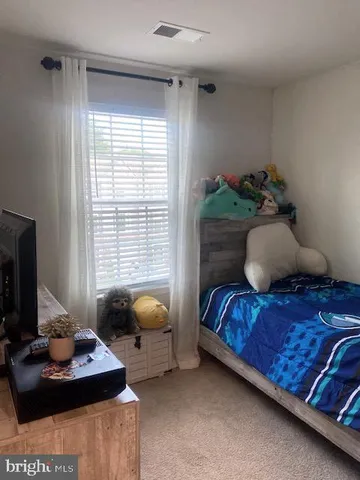 a bedroom with furniture and a window