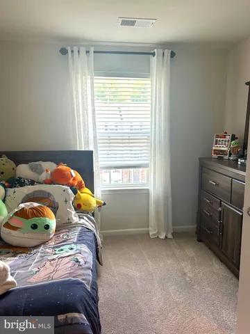 a bedroom with a bed and cabinets