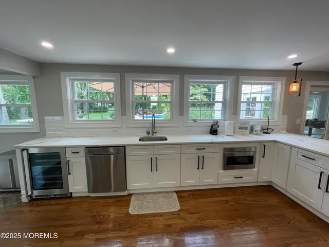 a large white kitchen with a large window