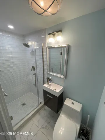 a bathroom with a sink toilet and shower