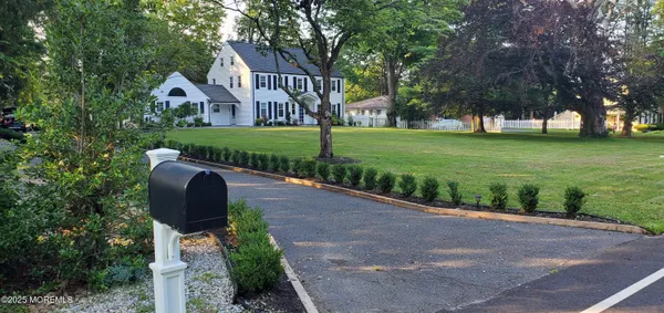 a front view of house with yard and green space