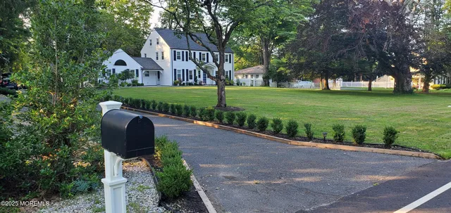 a front view of house with yard and green space