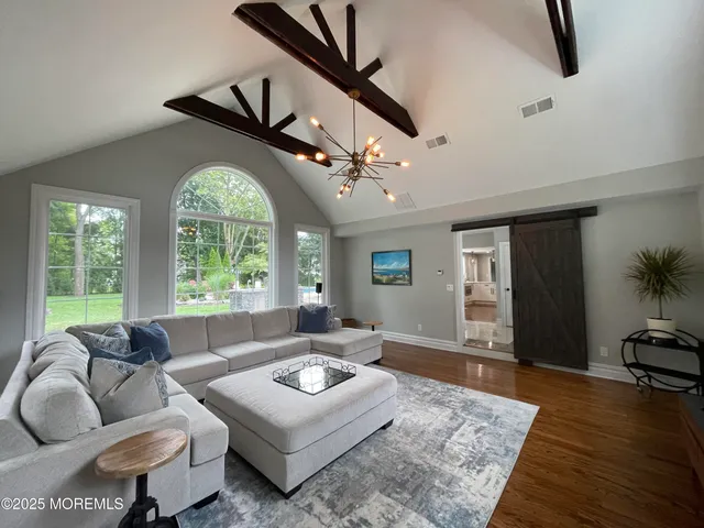 a living room with furniture a large window and a fireplace