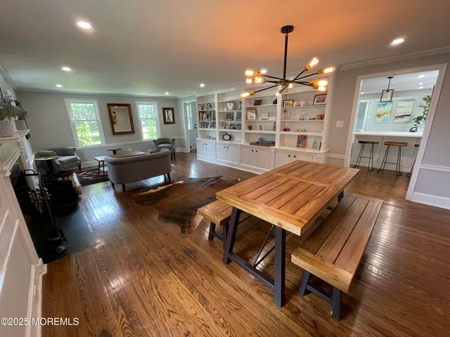 a living room with dining room and wooden floor