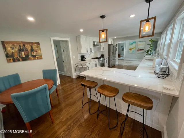 a view of a dining room with furniture and wooden floor