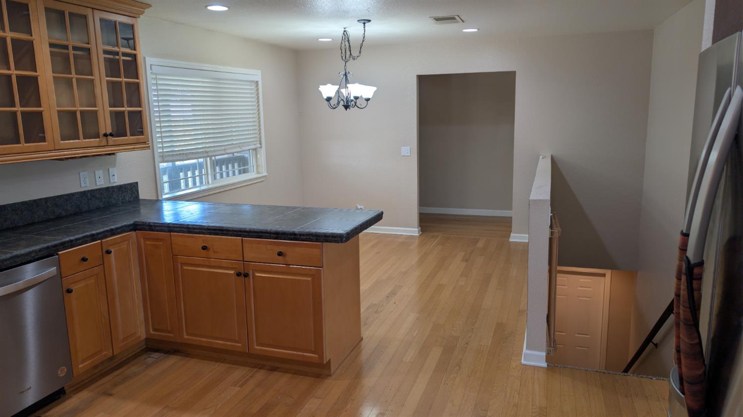 3248 Sudbury Road Cameron Park, CA 95682 - Photo 7 of 41 a kitchen with stainless steel appliances granite countertop cabinets and wooden floor