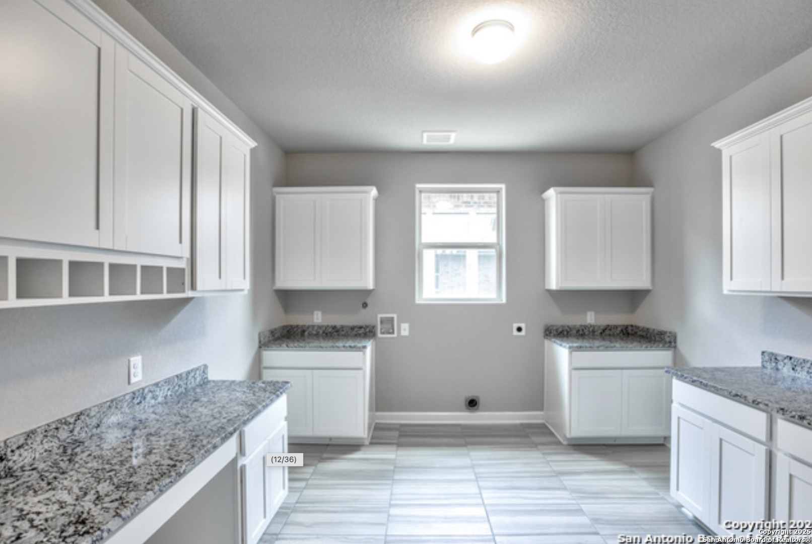 622 Singing Creek Spring Branch, TX 78070 - Photo 12 of 32 a kitchen with granite countertop a sink stove and cabinets