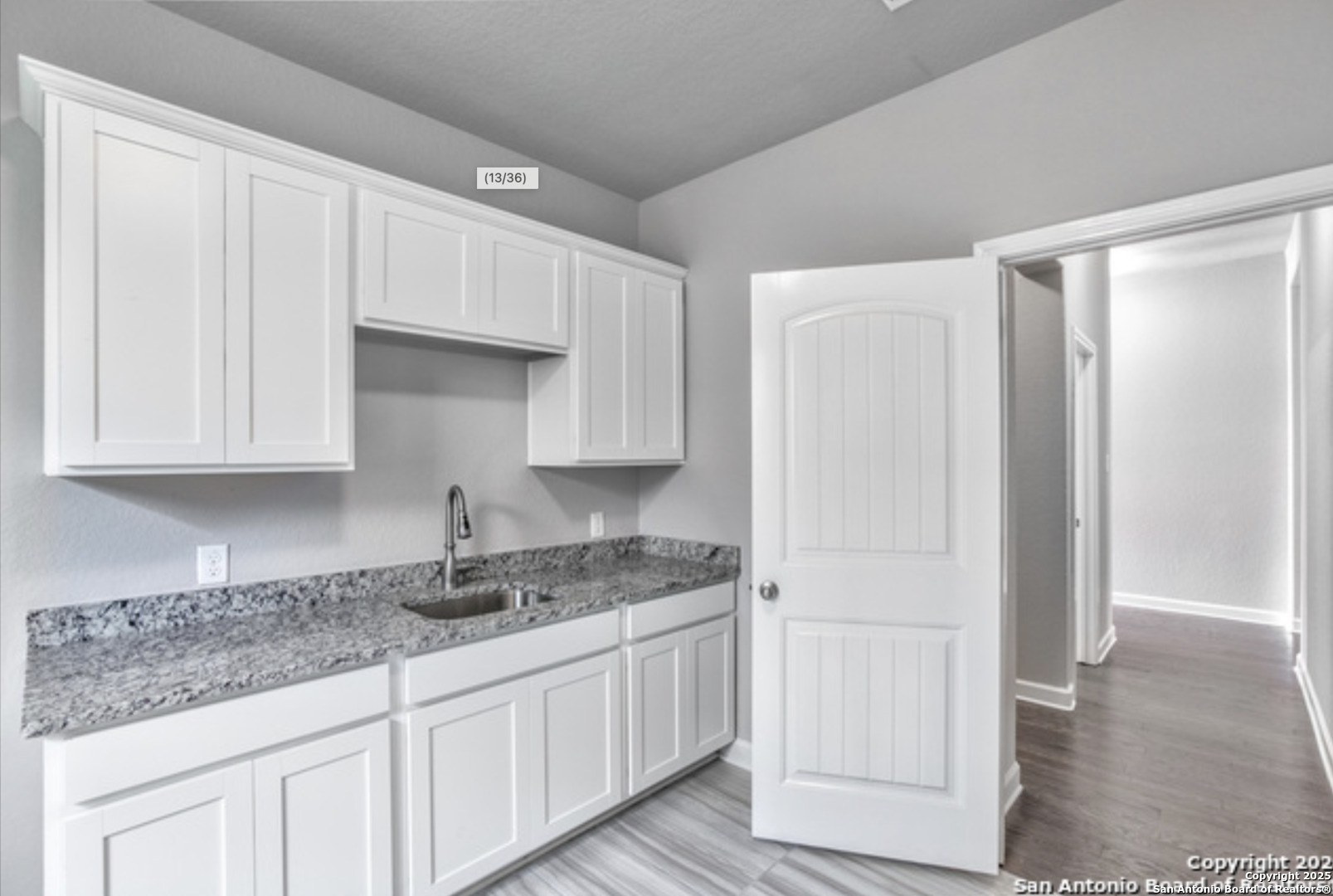 622 Singing Creek Spring Branch, TX 78070 - Photo 13 of 32 a kitchen with granite countertop white cabinets and sink