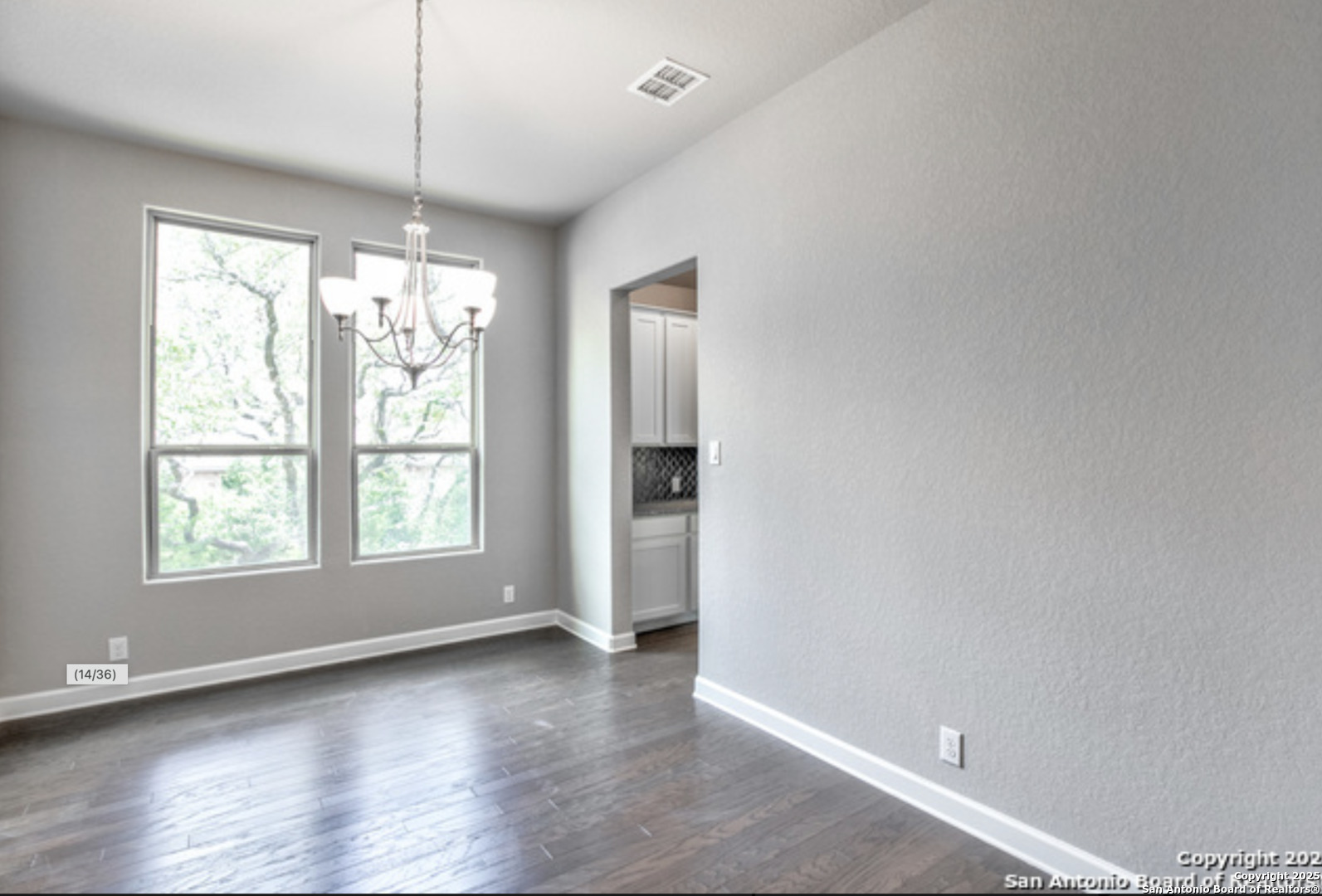 622 Singing Creek Spring Branch, TX 78070 - Photo 14 of 32 an empty room with wooden floor and windows