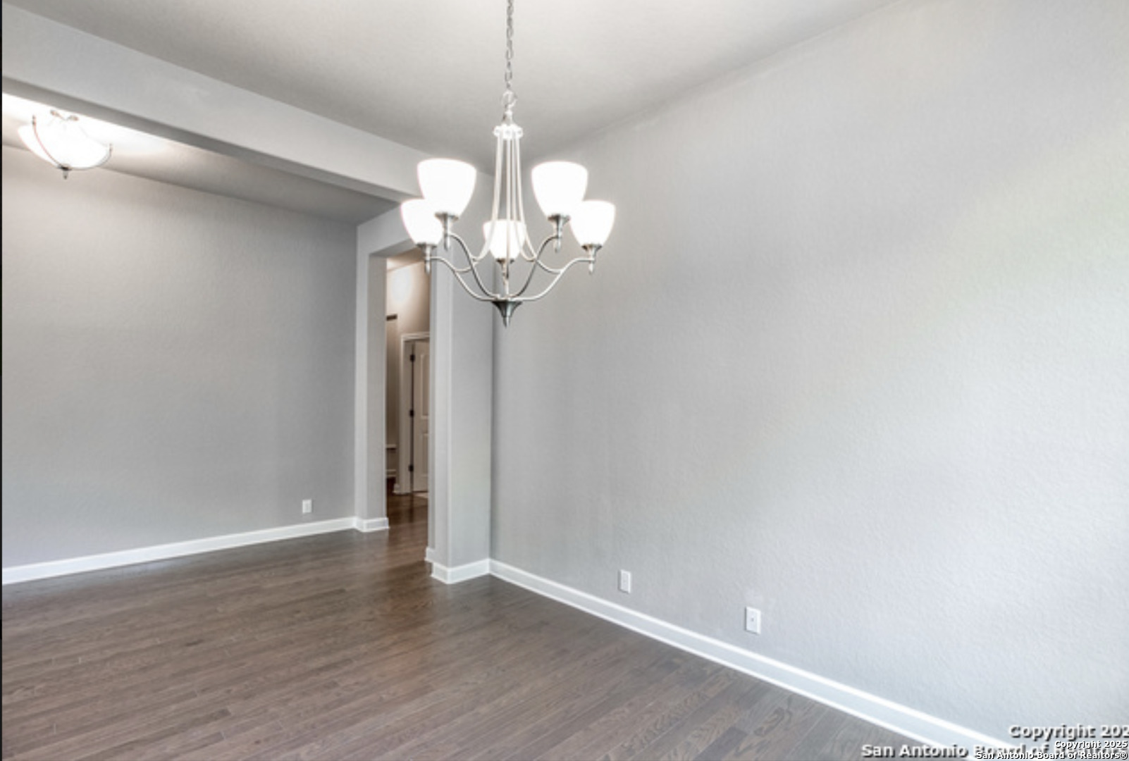 622 Singing Creek Spring Branch, TX 78070 - Photo 15 of 32 a view of a chandelier in a room with wooden floor