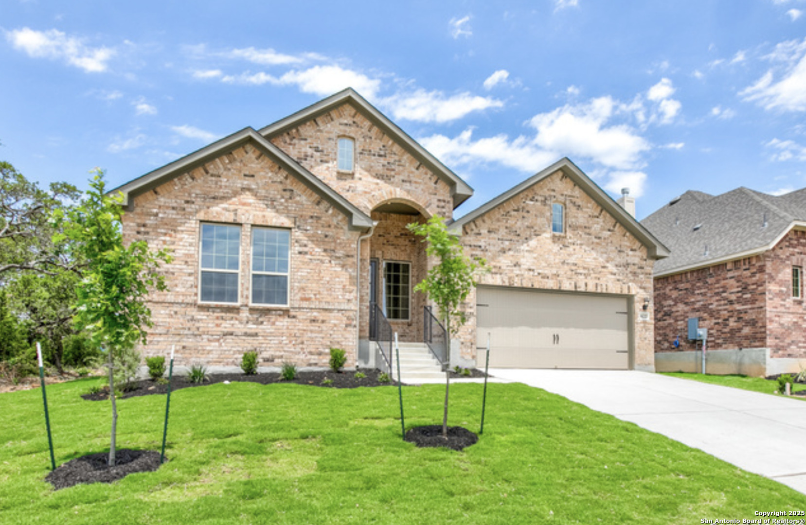 622 Singing Creek Spring Branch, TX 78070 - Photo 2 of 32 a view of a house with a yard and a garden