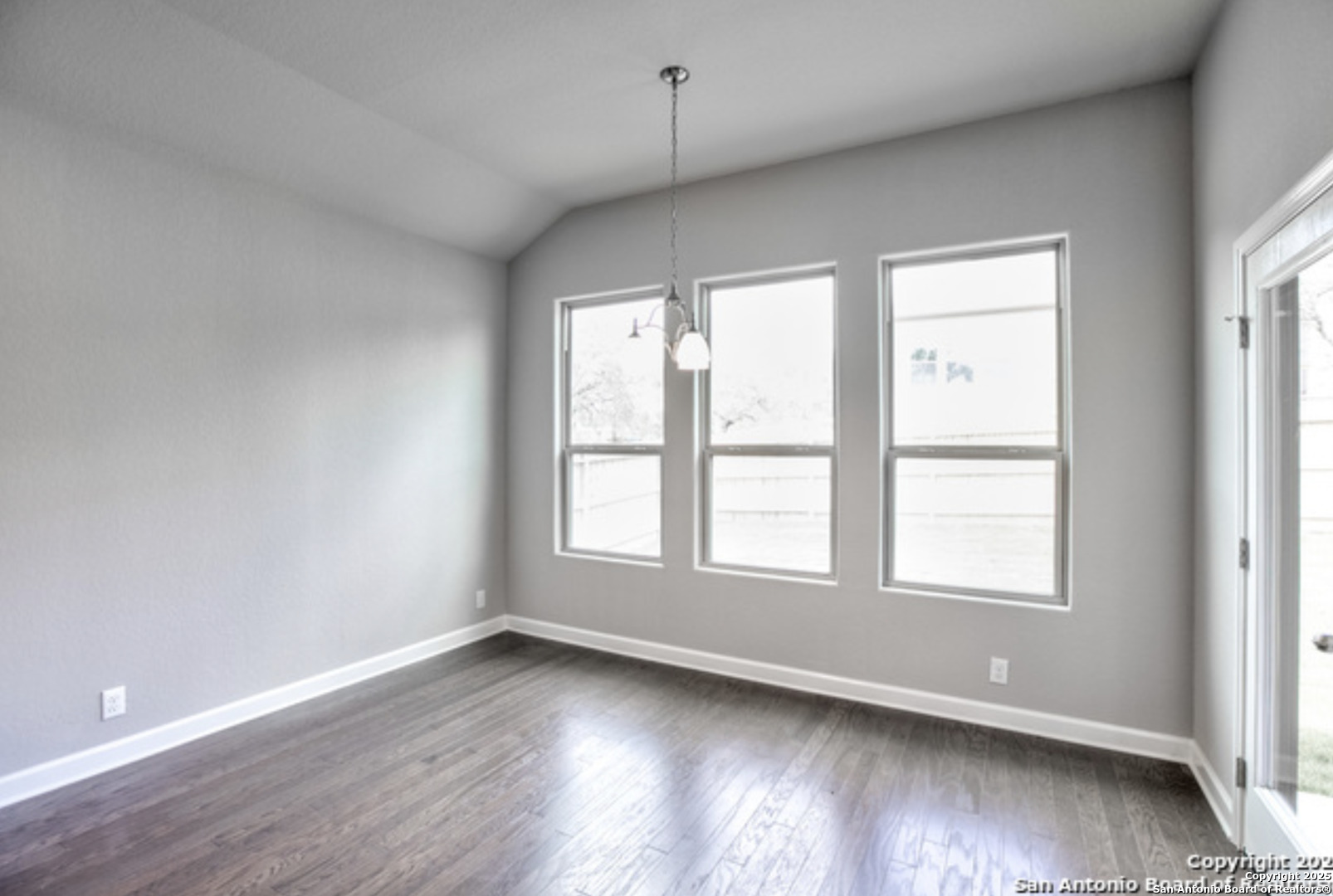 622 Singing Creek Spring Branch, TX 78070 - Photo 22 of 32 an empty room with wooden floor and windows