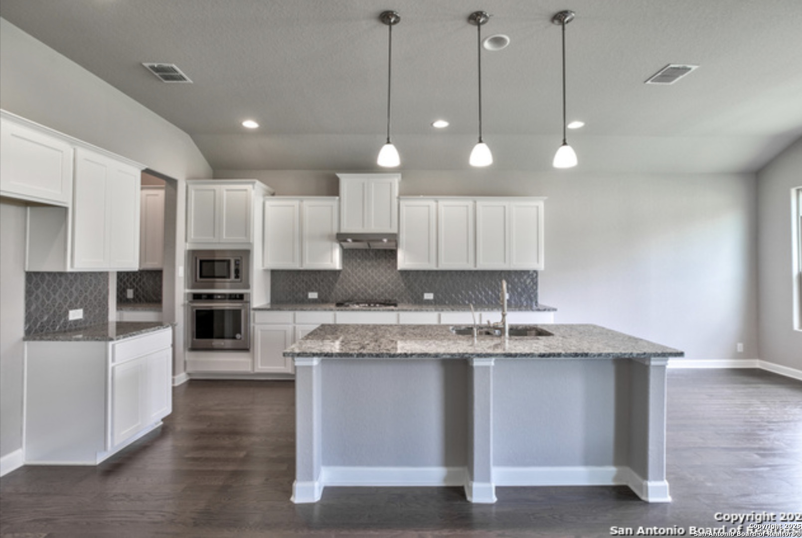 622 Singing Creek Spring Branch, TX 78070 - Photo 23 of 32 a large kitchen with stainless steel appliances kitchen island a large counter space a sink and cabinets