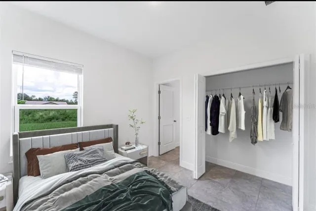 a bedroom with a bed and a window