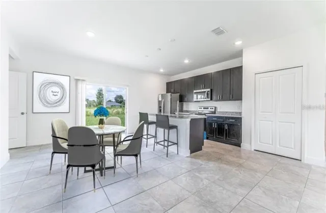 a dining room with furniture a window and kitchen view