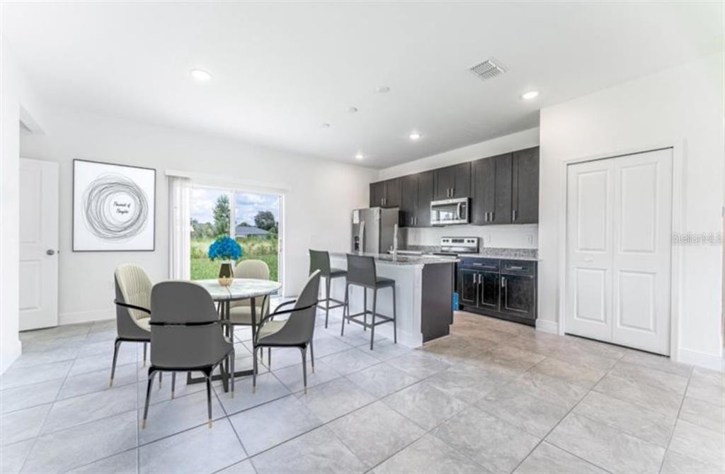 16262 Southwest 21st Terrace Road Ocala, FL 34473 - Photo 4 of 25 a dining room with furniture a window and kitchen view