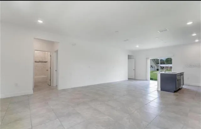 a kitchen with stainless steel appliances a sink a stove a microwave a refrigerator and cabinets