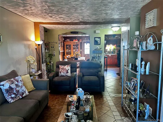 a living room with furniture and a bookshelf
