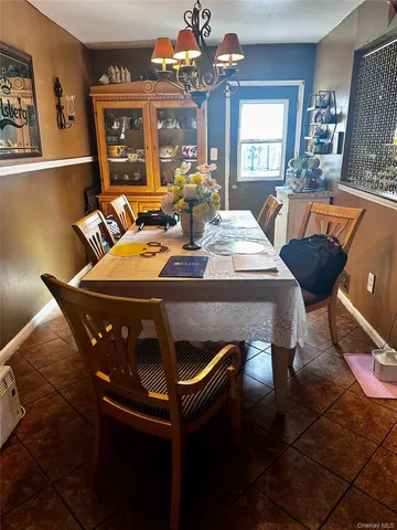 a view of a dining room with furniture and chandelier