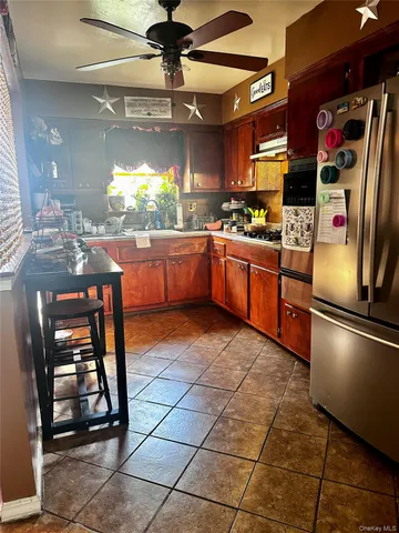 a kitchen with stainless steel appliances granite countertop a sink and a refrigerator
