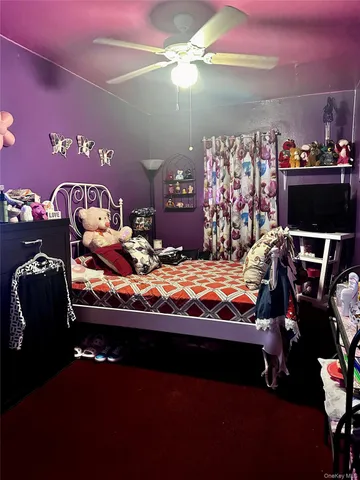 a bed sitting in a bedroom next to a lamp