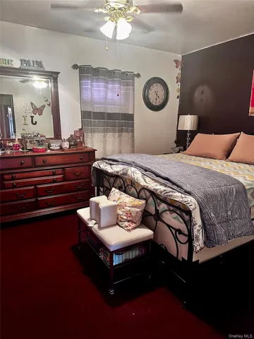 a bedroom with bed and a large mirror