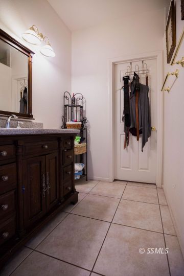 1516 South Farragut Street Ridgecrest, CA 93555 - Photo 19 of 24 a bathroom with a sink and a mirror