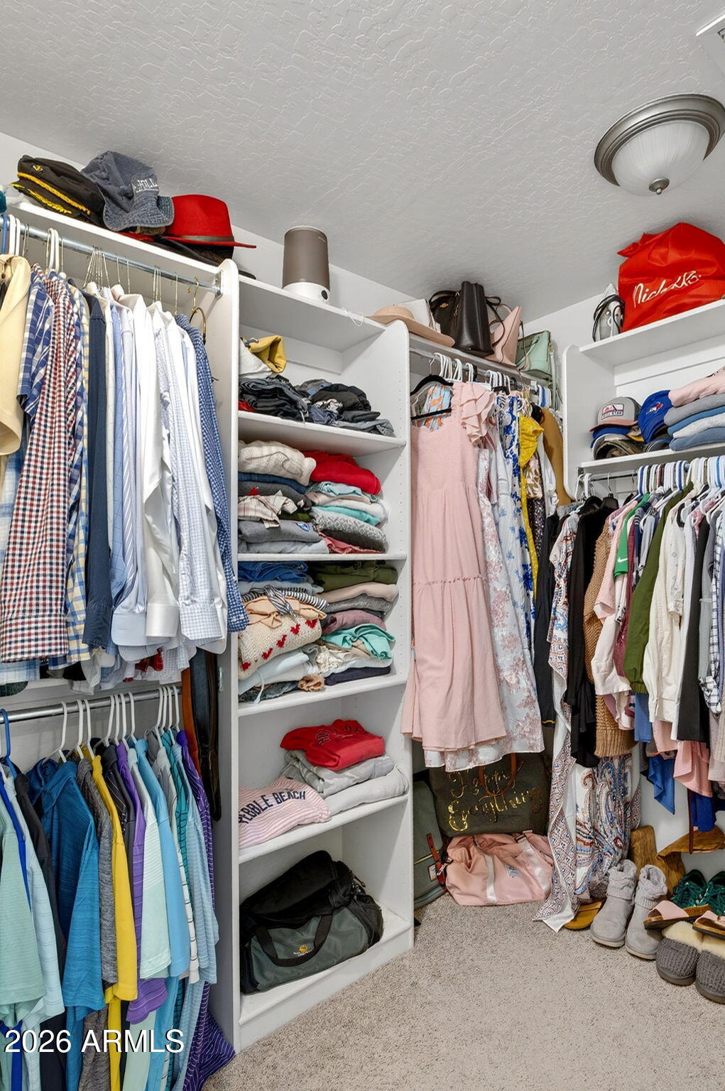 6280 South Sinova Court Gilbert, AZ 85298 - Photo 41 of 64 a view of walk in closet with clothes and shoes