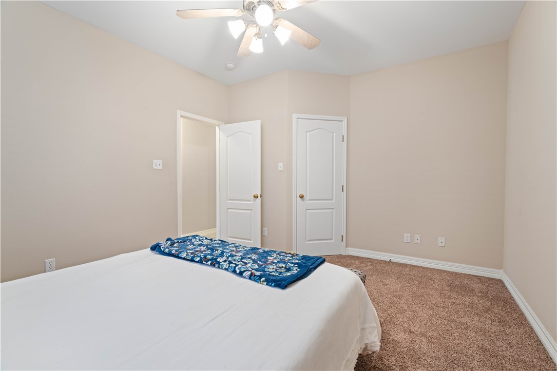 2601 Wool Drive Corpus Christi, TX 78414 - Photo 13 of 25 a bedroom with a bed and a chandelier