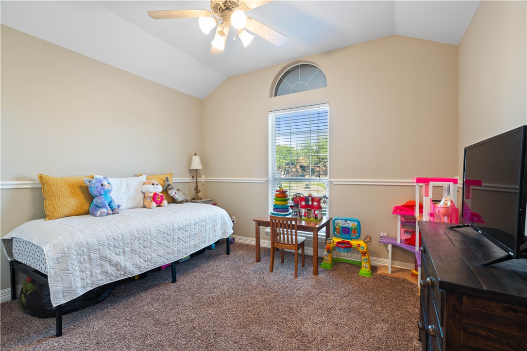 2601 Wool Drive Corpus Christi, TX 78414 - Photo 14 of 25 a bedroom with a bed and a chandelier